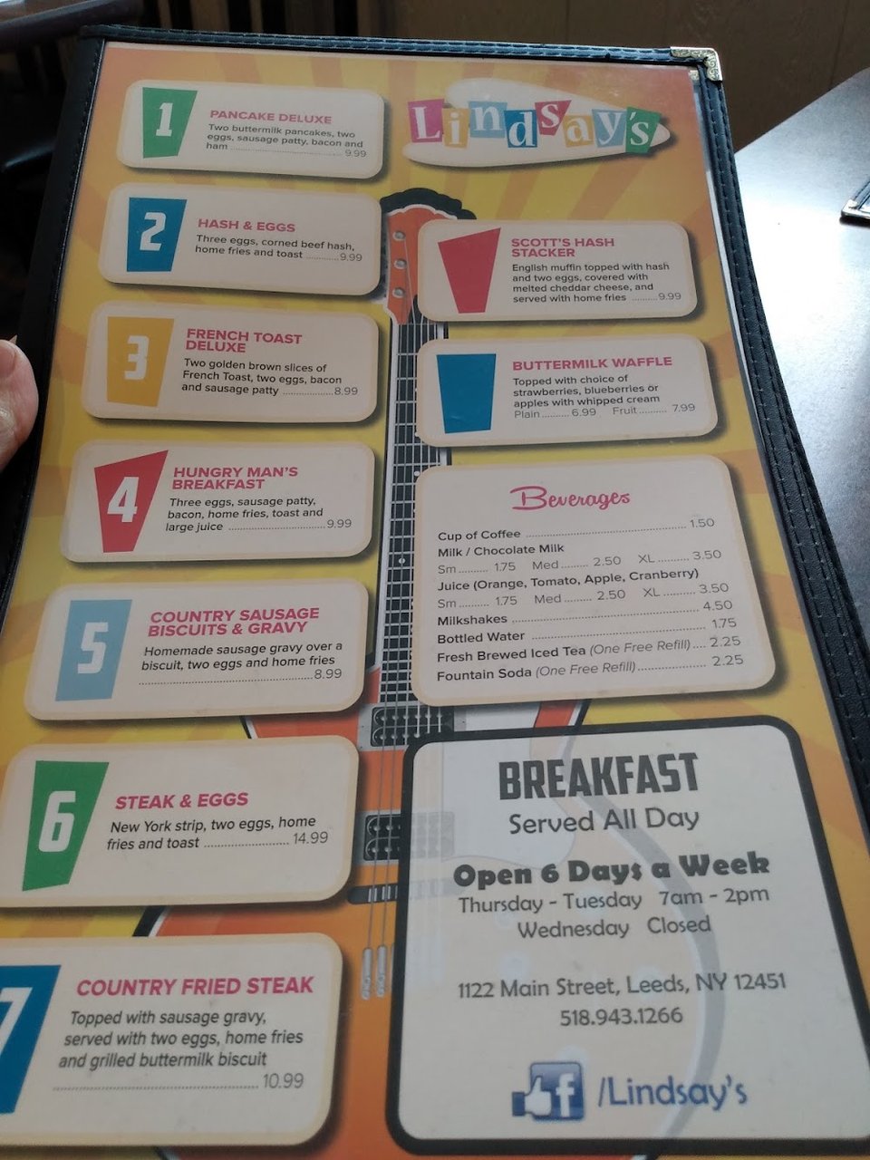 Printed menu beside a coffee cup.